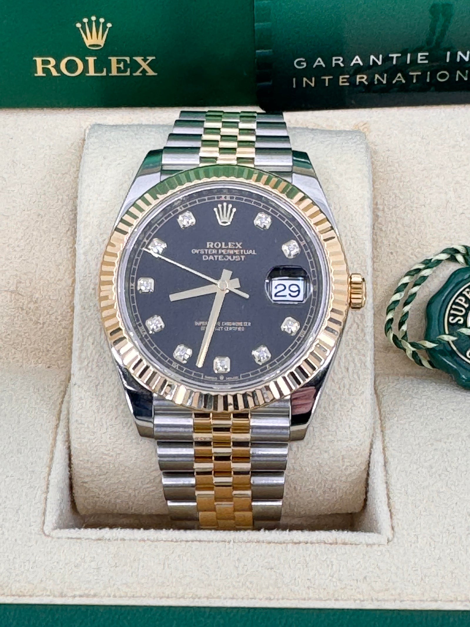 Gold rolex with black face and diamonds best sale